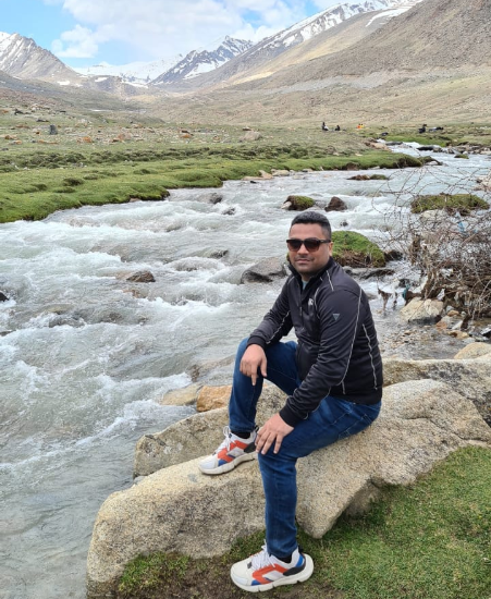 Photo of Sahil sitting near the river