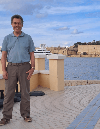 A holiday picture of David, with a water body background