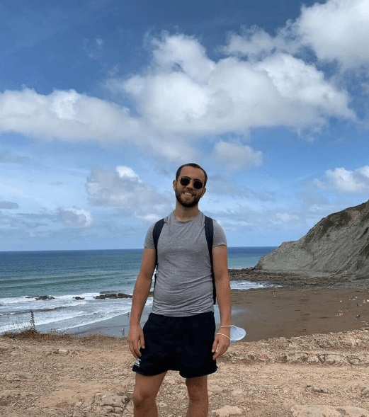 Image of Ale standing near the beach