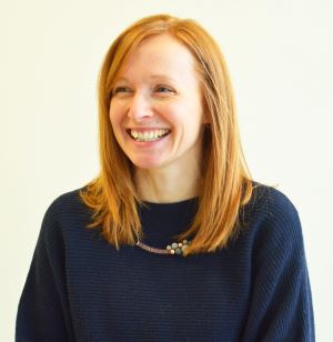 woman in a blue jumper smiling