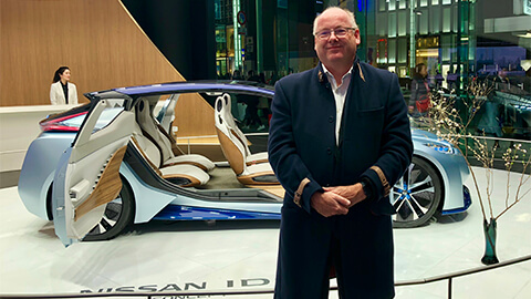 image of Jonathan in front of an electric car in Dubai