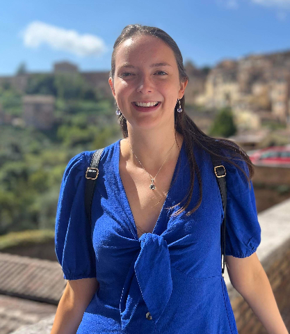 Photo of Jo smiling in a blue dress.