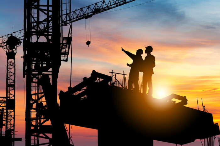 image of a couple of silhouettes on a building site