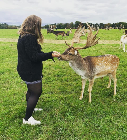Photo of Vitoria in the wild with a deer.
