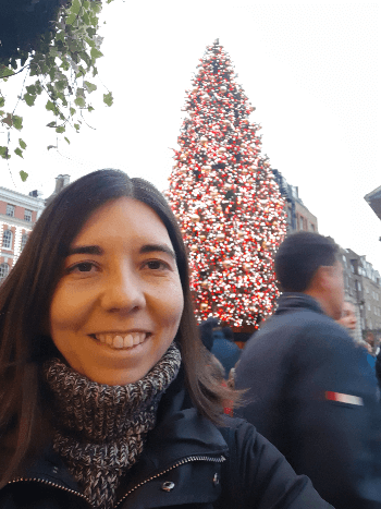 Photo of Clara with a Christmas tree