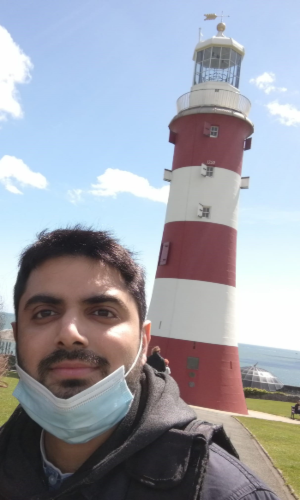 A picture of Tahir, with a lighthouse in the background