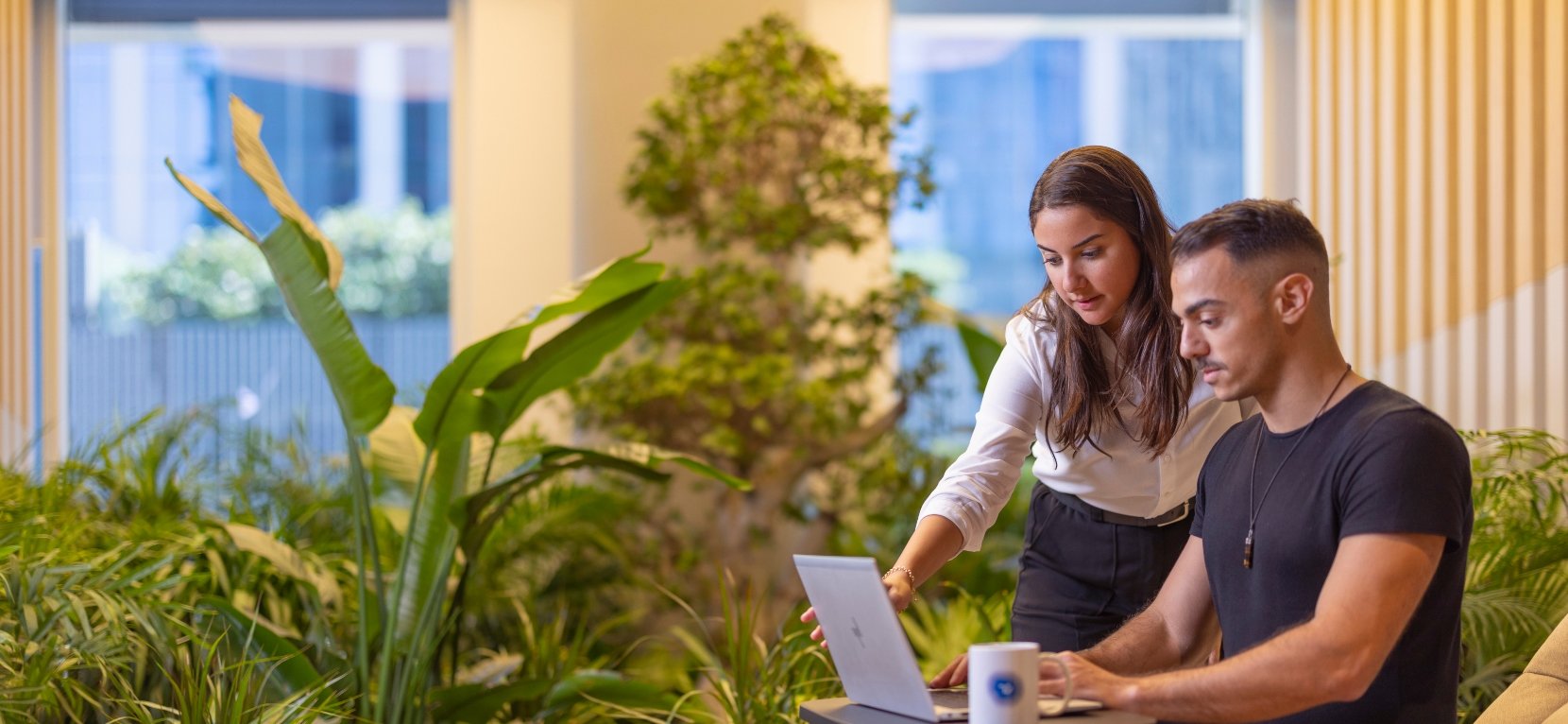 a man and woman seeing in laptop screen.