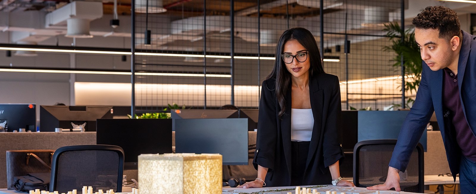 Woman and man looking at model plan