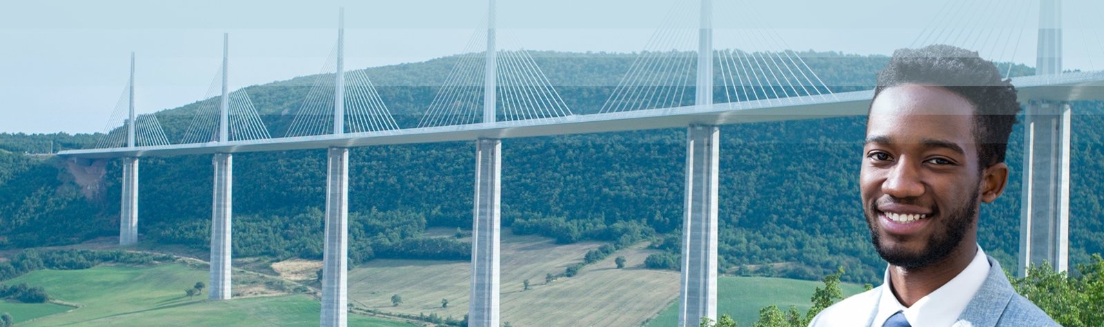 Smiling man in a suit with a modern cable-stayed bridge in the background, representing engineering or infrastructure development.