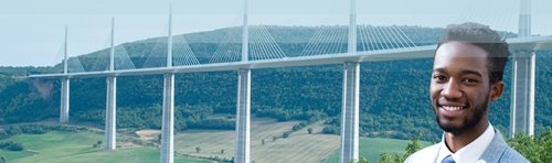 Smiling man in a suit with a modern cable-stayed bridge in the background, representing engineering or infrastructure development.