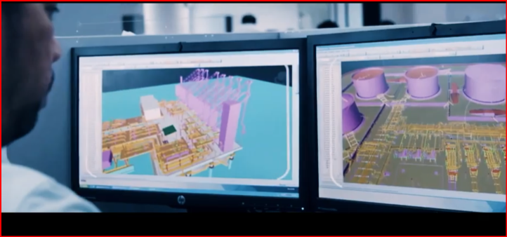 man looking at screens with digital images of nuclear power stations