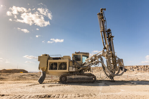 Large geotechnical drilling machine operating on construction site