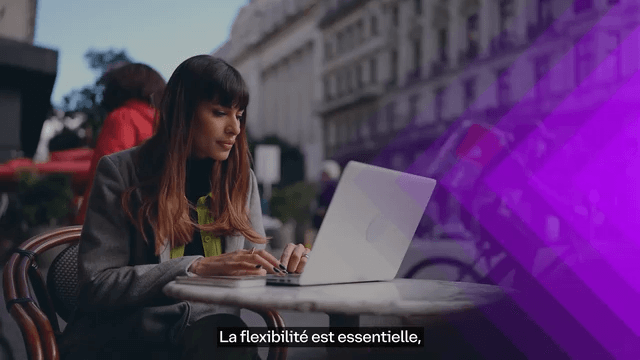 a woman sitting with working on laptop