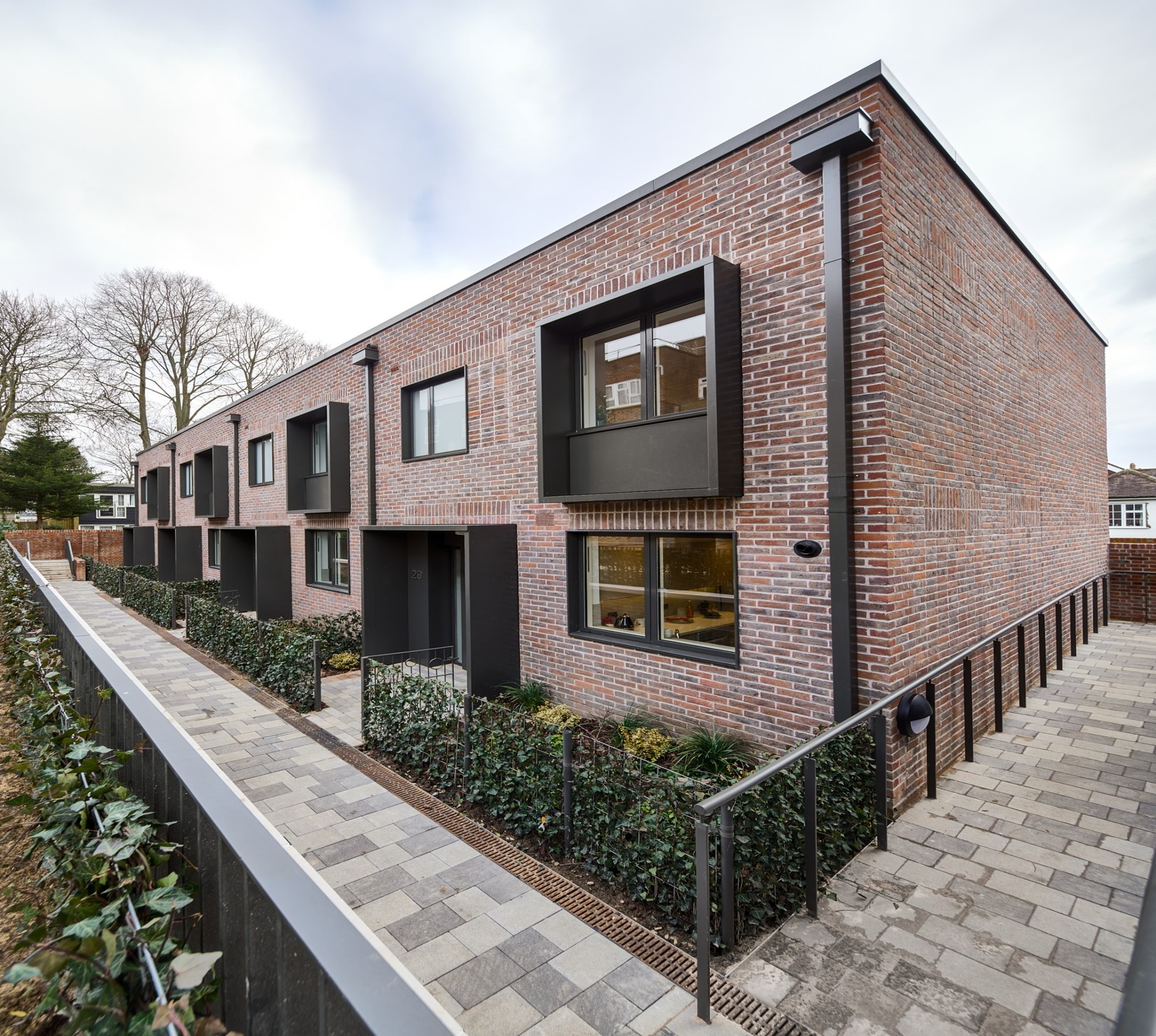 Modern brick housing development with black-framed windows