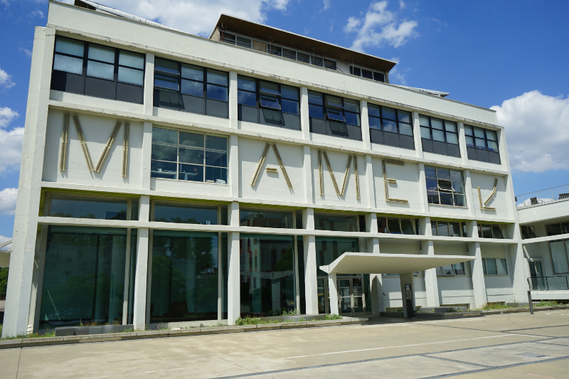 White building with "NAME" on facade
