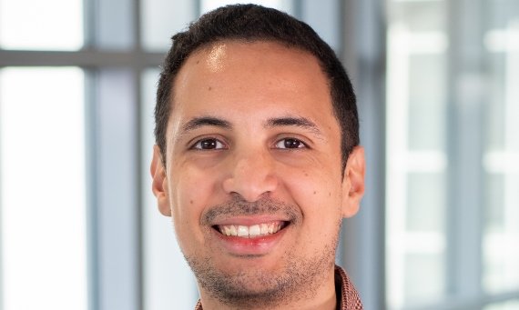 Man smiling with arms crossed