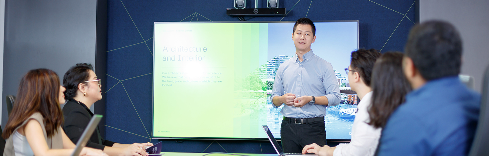 a man explaining the PPT in office room.