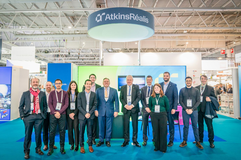 Group photo at AtkinsRéalis booth