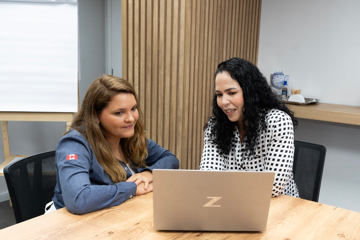Two women working at a laptop