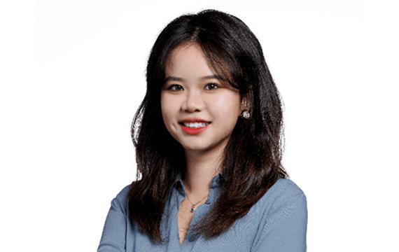 Headshot of a young Asian woman with long dark hair, wearing a light blue shirt and smiling confidently against a white background.