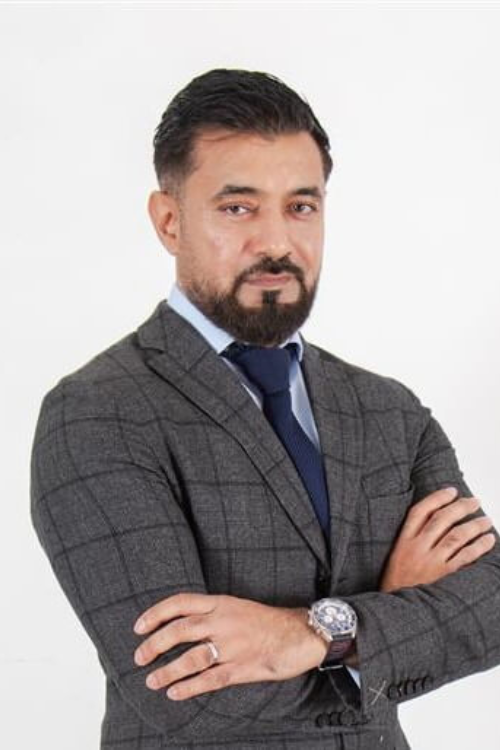 man wearing suits and folding his hands.