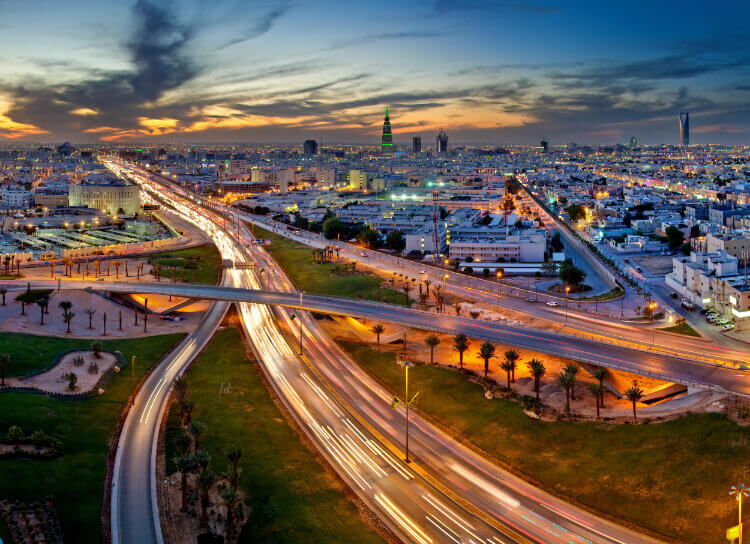 City highway with light trails at sunset