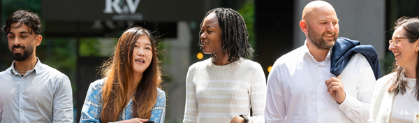 group of smiling and talking employees in Manchester, UK