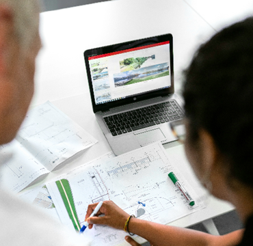 two people discussing a plan on a screen 