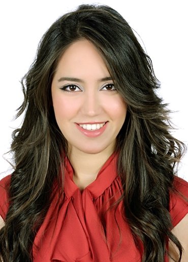 Smiling woman with long dark hair wearing a red top, portrait on a white background.