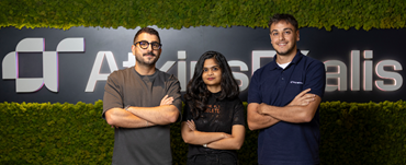 3 people standing in front of AtkinsRealis branding display