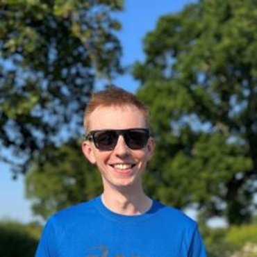 Man wearing sunglasses smiling outdoors