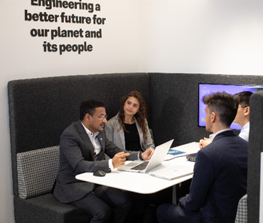 team of four people round a table in an AtkinsRéalis office