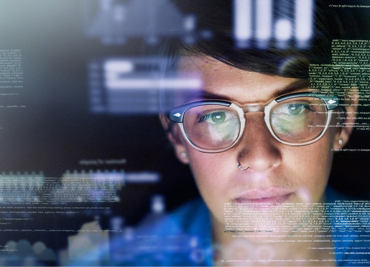 person wearing glasses looking at a screen