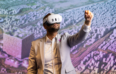 AtkinsRéalis image of a man wearing an AI headset reaching his left arm out