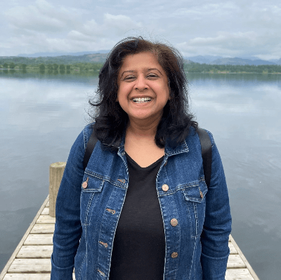 Photo of Kiran smiling towards the camera