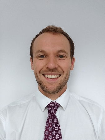 Photo of Ben smiling towards the camera