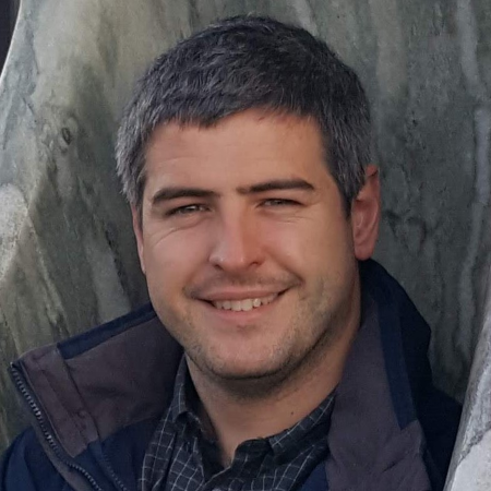 Photo of Joe smiling towards the camera