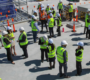 A group of engineers talking to each other on site
