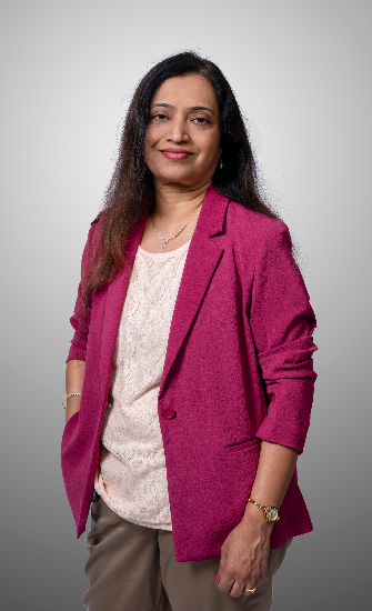 A picture of Shaila smiling in a pink jacket