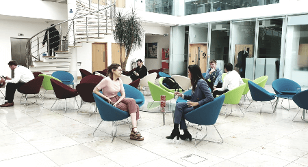 Photo of veronica chatting with a colleague