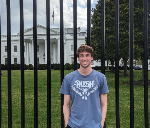 A picture of Euan standing in front of the White House