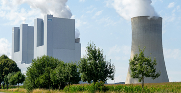 A nuclear plant with smoke releasing from the tower