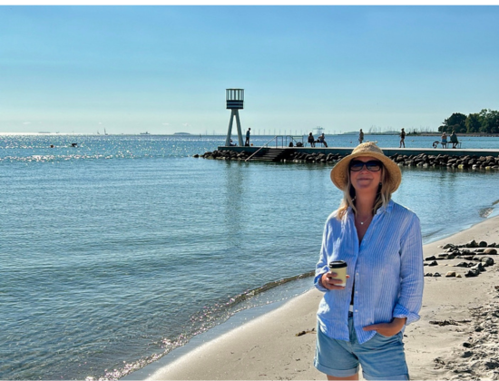 Jo standing near water