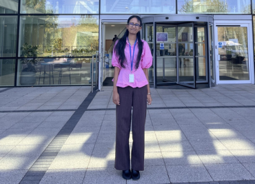 Mrudula standing in front of the office building