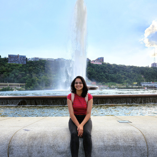 Advika sitting front of a fountain