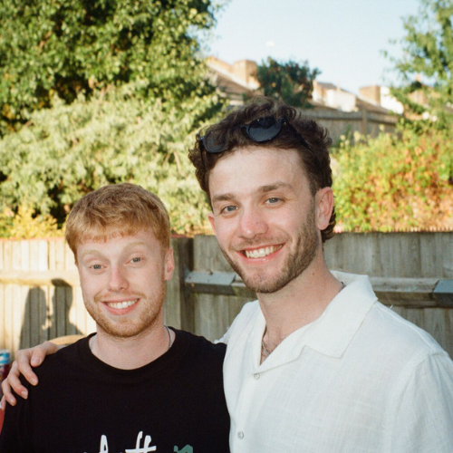 Matthew and his friend smiling at the camera
