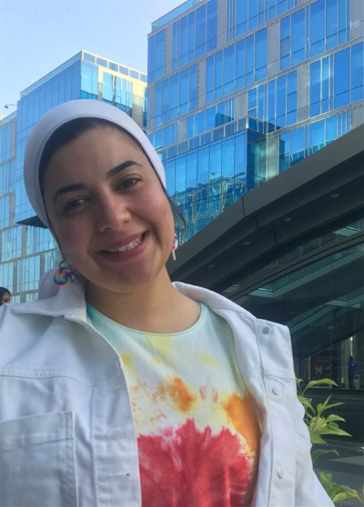 Image of Merna standing near a blog