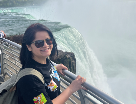 Piriya standing near a waterfall