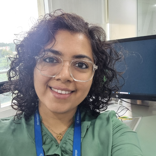 Image of Remya at her desk in office