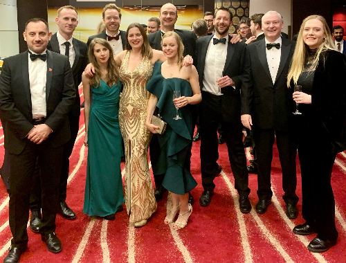 A group picture of Tracey and her colleagues at an award ceremony